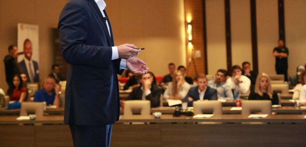 person presenting in front of a room of people